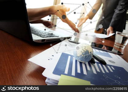 business documents on office table with smart phone and digital tablet and graph business diagram and man working in the background