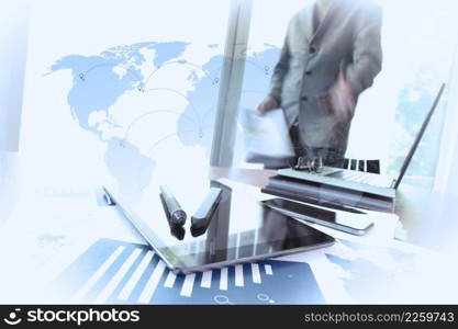 business documents on office table with smart phone and digital tablet and man working in the background with social media diagram