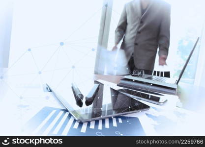 business documents on office table with smart phone and digital tablet and man working in the background with social media diagram