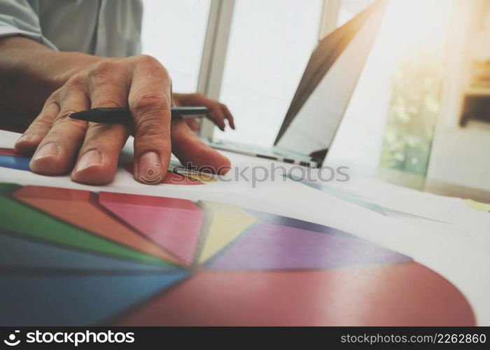 business documents on office table with smart phone and digital tablet and graph business diagram and man working in the background