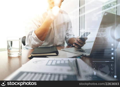 business documents on office table with smart phone and digital tablet and graph business diagram and man working in the background