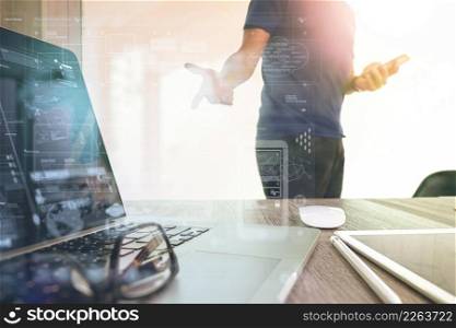 business documents on office table with smart phone and digital tablet and graph business with social network diagram and man working in the background