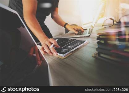 business documents on office table with smart phone and digital tablet and graph business with stack book and man working in the background