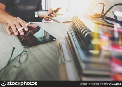 business documents on office table with smart phone and digital tablet and graph business with social network diagram and man working in the background