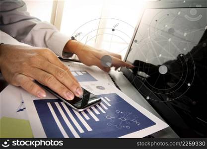 business documents on office table with smart phone and digital tablet with laptop computer and man working in moment