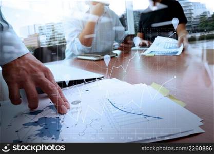business documents on office table with smart phone and laptop computer and graph business with social network diagram and two colleagues discussing data in the background