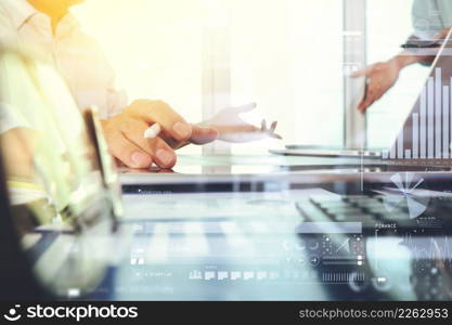 business documents on office table with smart phone and laptop computer and graph business with social network diagram and two colleagues discussing data in the background