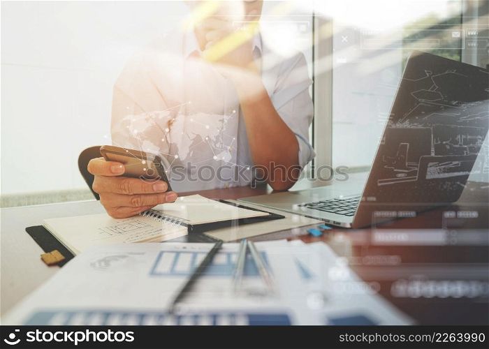 business documents on office table with smart phone and laptop computer and graph business diagram and man working in the background