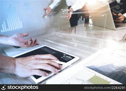 business documents on office table with smart phone and laptop computer and digital graph business with social network diagram and three colleagues discussing data in the background
