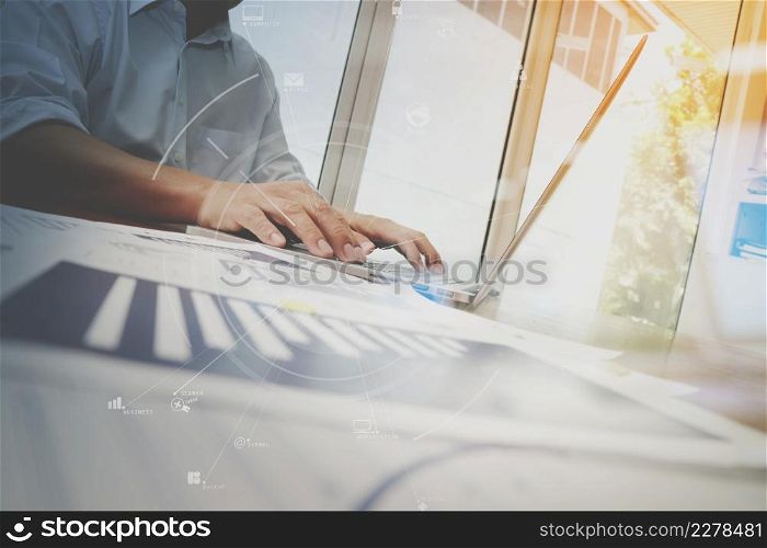 business documents on office table with smart phone and laptop computer and graph business with social network diagram and man working in the background