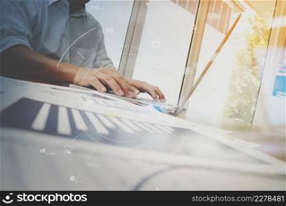 business documents on office table with smart phone and laptop computer and graph business with social network diagram and man working in the background