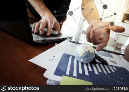 business documents on office table with texture the world on digital tablet and man using smart phone in the background Elements of this image furnished by NASA