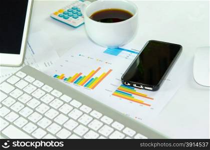 business documents with charts growth, keyboard and smart phone. workplace businessman