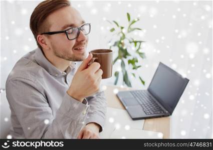 business, drinks and people concept - happy businessman or creative man drinking coffee at home office over snow