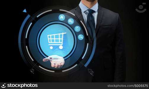 business, e-commerce, future technology, cyberspace and people - close up of businessman with virtual shopping cart projection over black background. businessman with virtual shopping cart projection