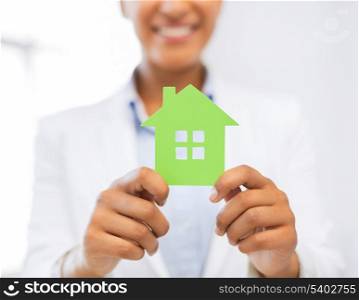business, eco, real estate concept - closeup picture of woman hands holding green house