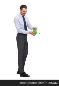 business, ecology and office concept - handsome buisnessman with green watering can