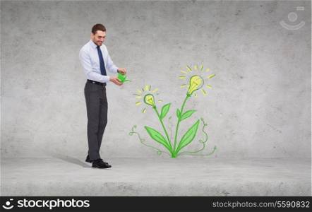 business, ecology and office concept - handsome businessman with green watering can showering flower with light bulbs