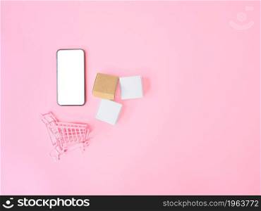 Business ecommerce and online shopping concepts from smartphone with blank screen and product box order on pink background. Top view