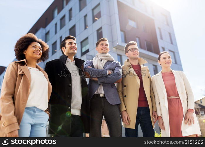 business, education and corporate concept - international group of people on city street. international group of people on city street