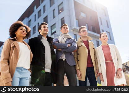 business, education and corporate concept - international group of people on city street. international group of people on city street