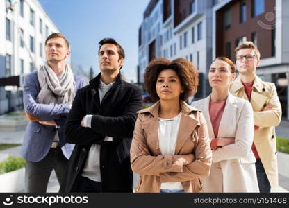 business, education and corporate concept - international group of people on city street. international group of people on city street