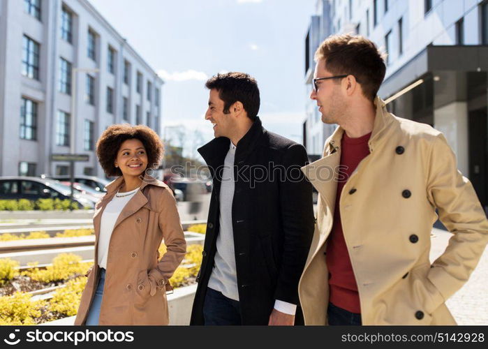 business, education and corporate concept - international group of people or friends on city street. international group of people on city street