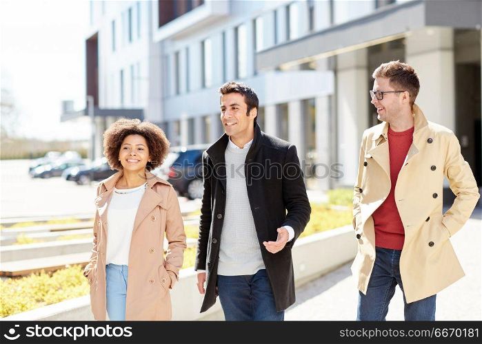 business, education and corporate people concept - office workers or friends talking on city street. office workers or friends talking on city street. office workers or friends talking on city street