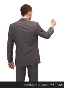 business, education and office concept - businessman or teacher with marker writing or drawing something imaginary from back