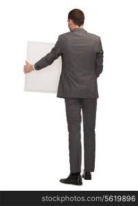 business, education and office concept - businessman or teacher with white big board from back