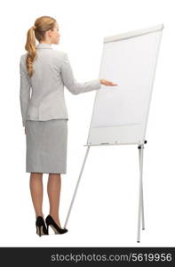 business, education and office concept - businesswoman or teacher showing something imaginary on whiteboard from back