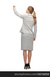 business, education and office concept - businesswoman or teacher with marker writing or drawing something imaginary from back