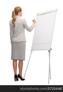 business, education and office concept - businesswoman or teacher with marker writing or drawing something imaginary on whiteboard from back