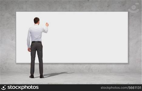 business, education and office people concept - businessman or teacher with marker writing or drawing something on white blank board over concrete wall background from back