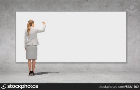 business, education and office people concept - businesswoman or teacher with marker writing or drawing something on white blank board over concrete wall background from back
