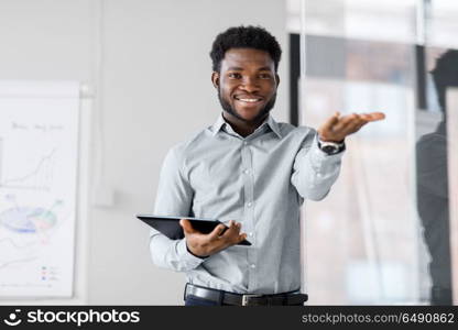 business, education and people concept - african american businessman with tablet pc computer at office presentation. businessman with tablet pc at office presentation. businessman with tablet pc at office presentation