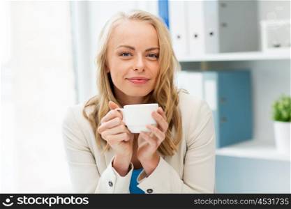 business, education and people concept - happy young businesswoman or student girl drinking coffee at office