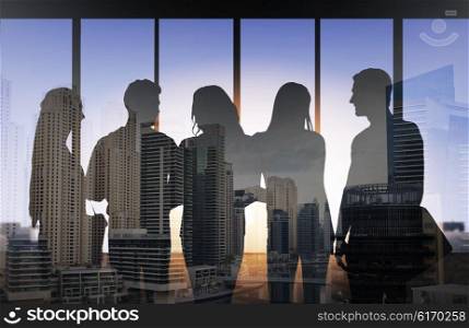 business, education and people concept - people silhouettes over double exposure office and city background