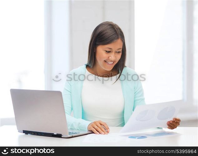 business, education and technology concept - asian businesswoman or student with laptop and documents in office