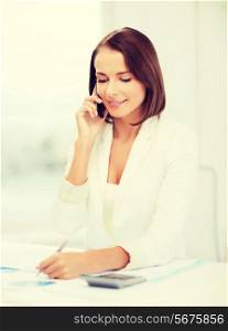 business, education and technology concept - smiling businesswoman with smartphone papers and calculator in office