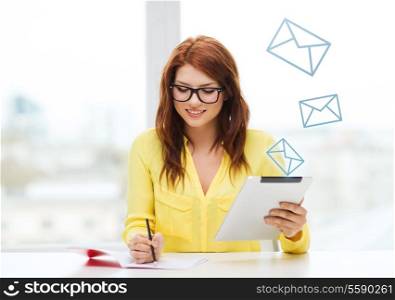 business, education and technology concept - smiling student in eyeglasses with tablet pc computer and notebook in college
