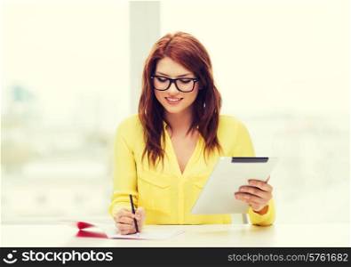 business, education and technology concept - smiling student in eyeglasses with tablet pc computer and notebook in college