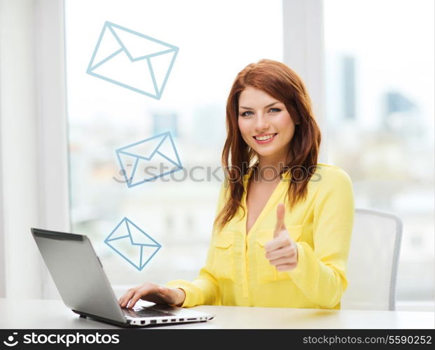 business, education and technology concept - smiling student with book laptop computer at school showing thumbs up