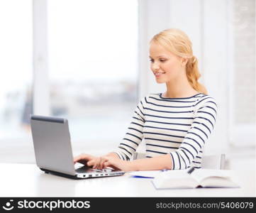 business, education and technology concept - smiling student with book, laptop computer and notebook in college