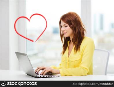 business, education and technology concept - smiling student with book laptop computer at school