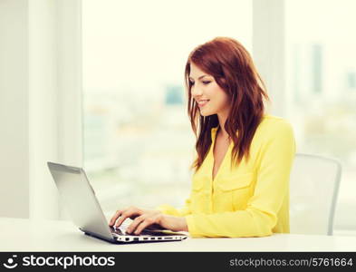 business, education and technology concept - smiling student with book laptop computer at school