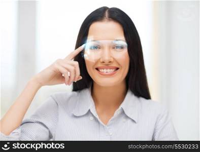 business, education and technology concept - smiling woman pointing to virtual futuristic glasses