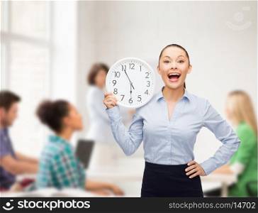 business, education and time concept - attractive teacher with wall clock