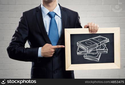 Business education. Close up of businessman holding chalkboard with business ideas