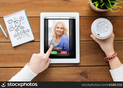 business, education, communication, technology and people concept - close up of woman with incoming call tablet pc computer screen and coffee on wooden table